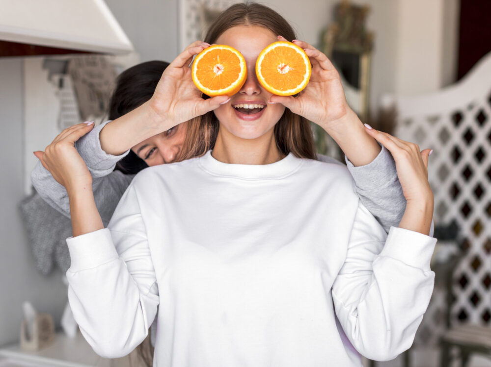 young-women-playing-with-oranges