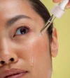 Close-up of woman applying serum on face Close-up of woman applying serum on face